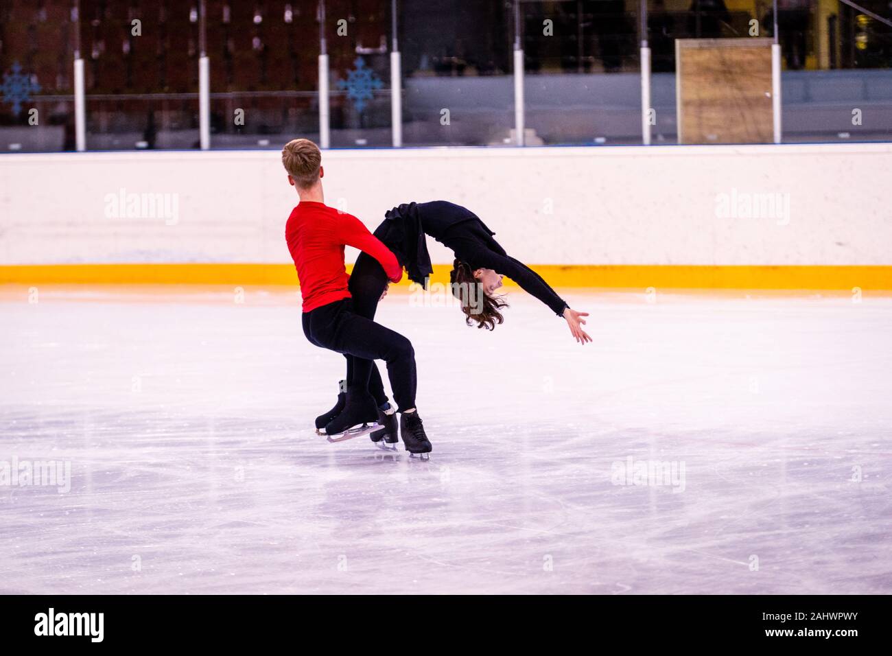 ice arena figure skating training. a pair of young figure skaters