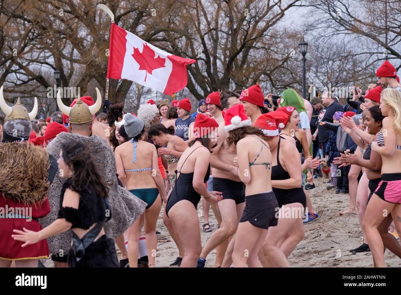 Toronto, Ontario, Canada. January 1st, 2020.  Over 300 registered participants gather to “do the dip” at Sunnyside Beach in Lake Ontario with temperature hovering around the freezing point. Stock Photo