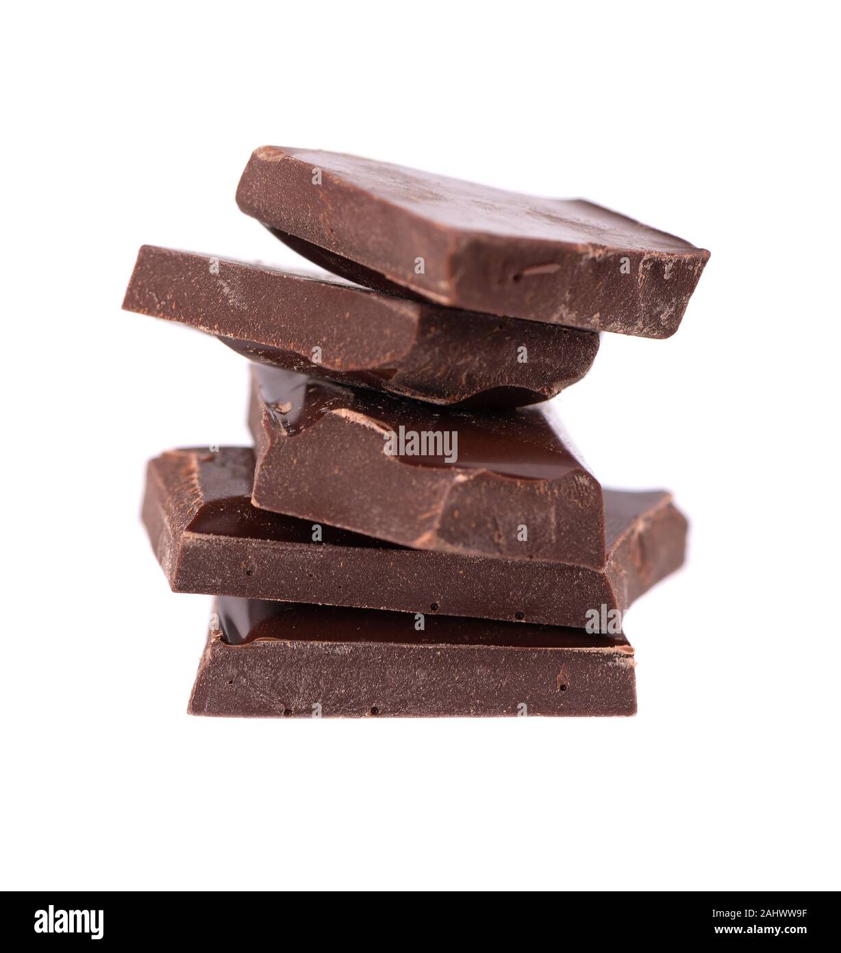 Chocolate pieces stack isolated on white background. Close up. Stock Photo