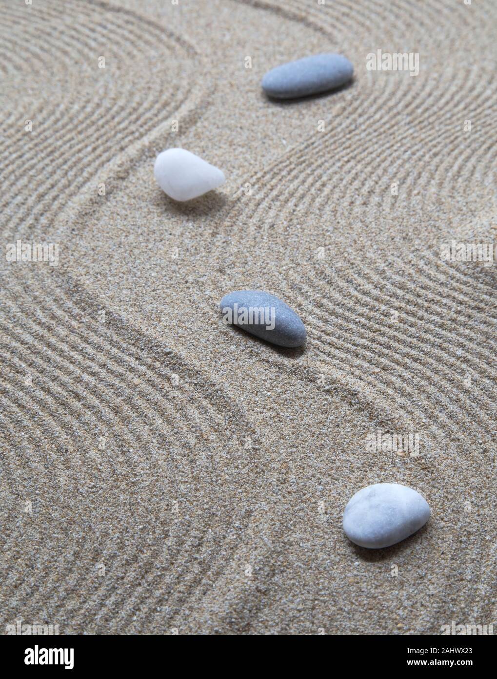 Mini zen garden with stones and sand pattern Stock Photo Alamy