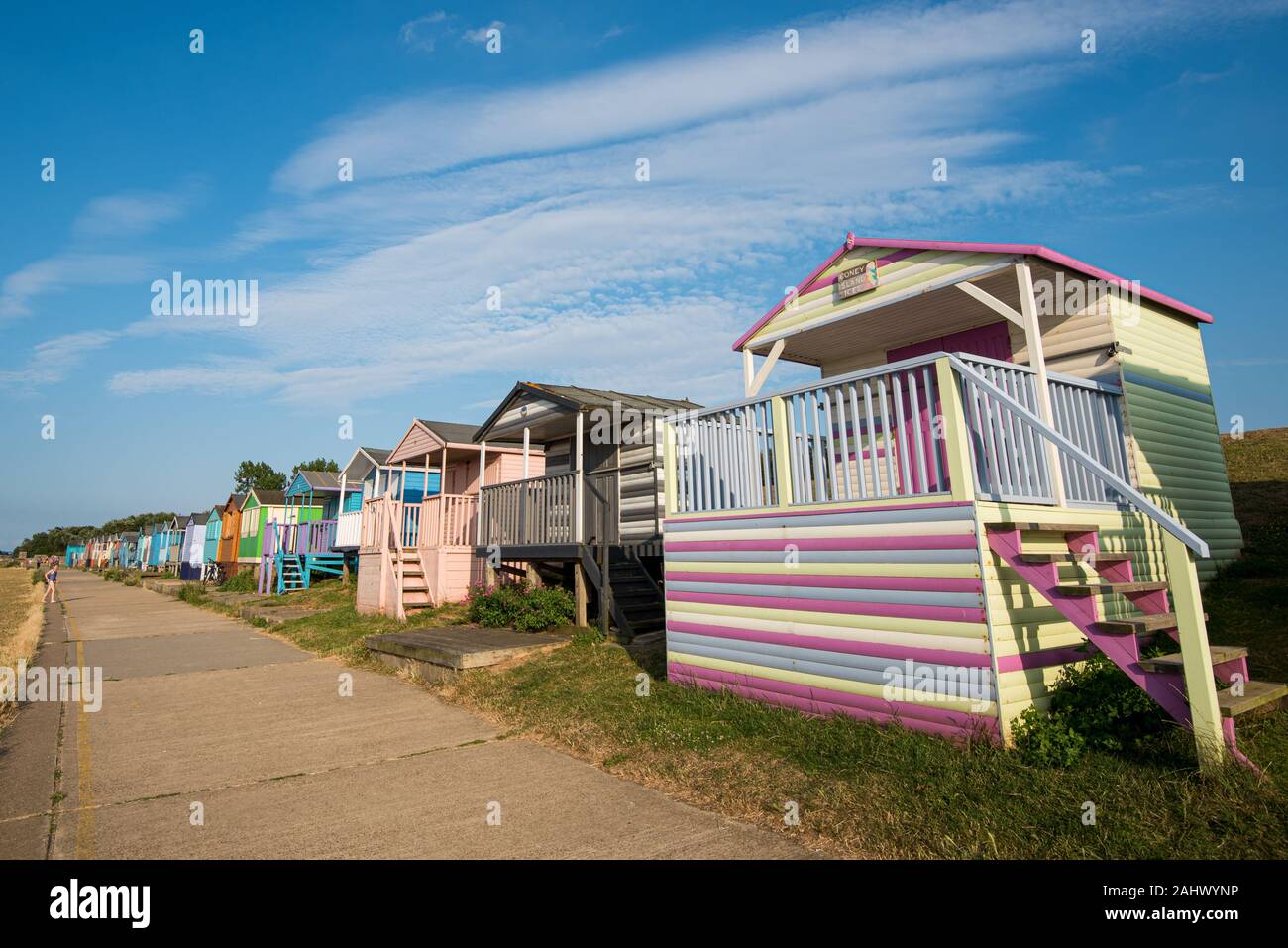 Multicoloured holiday wooden beach huts facing the ocean on the beach