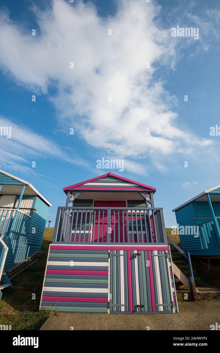 Multi-coloured holiday wooden beach huts facing the ocean  on the beach of Tankerton Whitstable coast,  Kent district England. Stock Photo