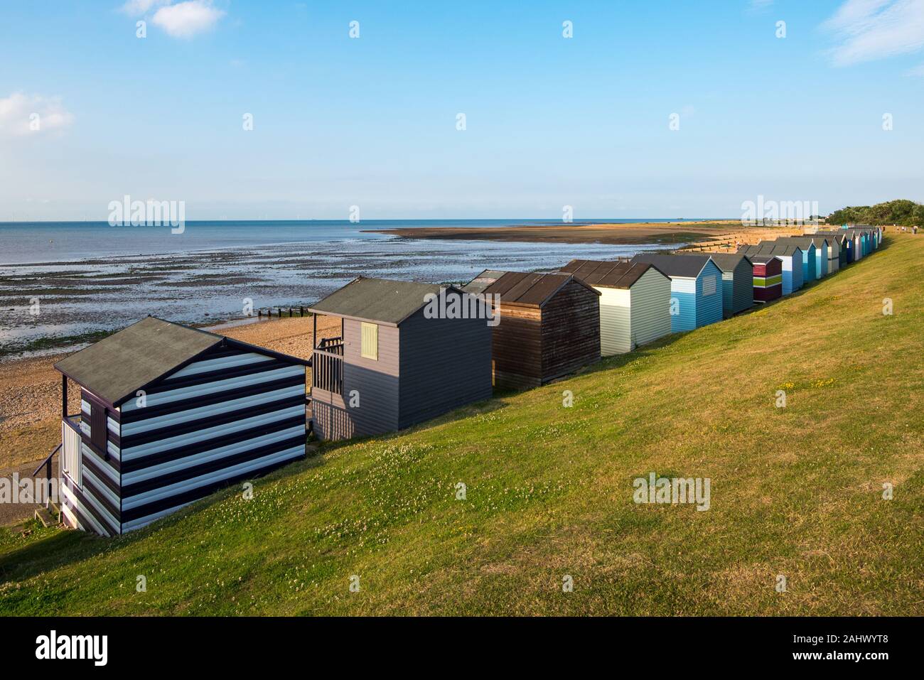 Multi-coloured holiday wooden beach huts facing the ocean  on the beach of Tankerton Whitstable coast,  Kent district England. Stock Photo