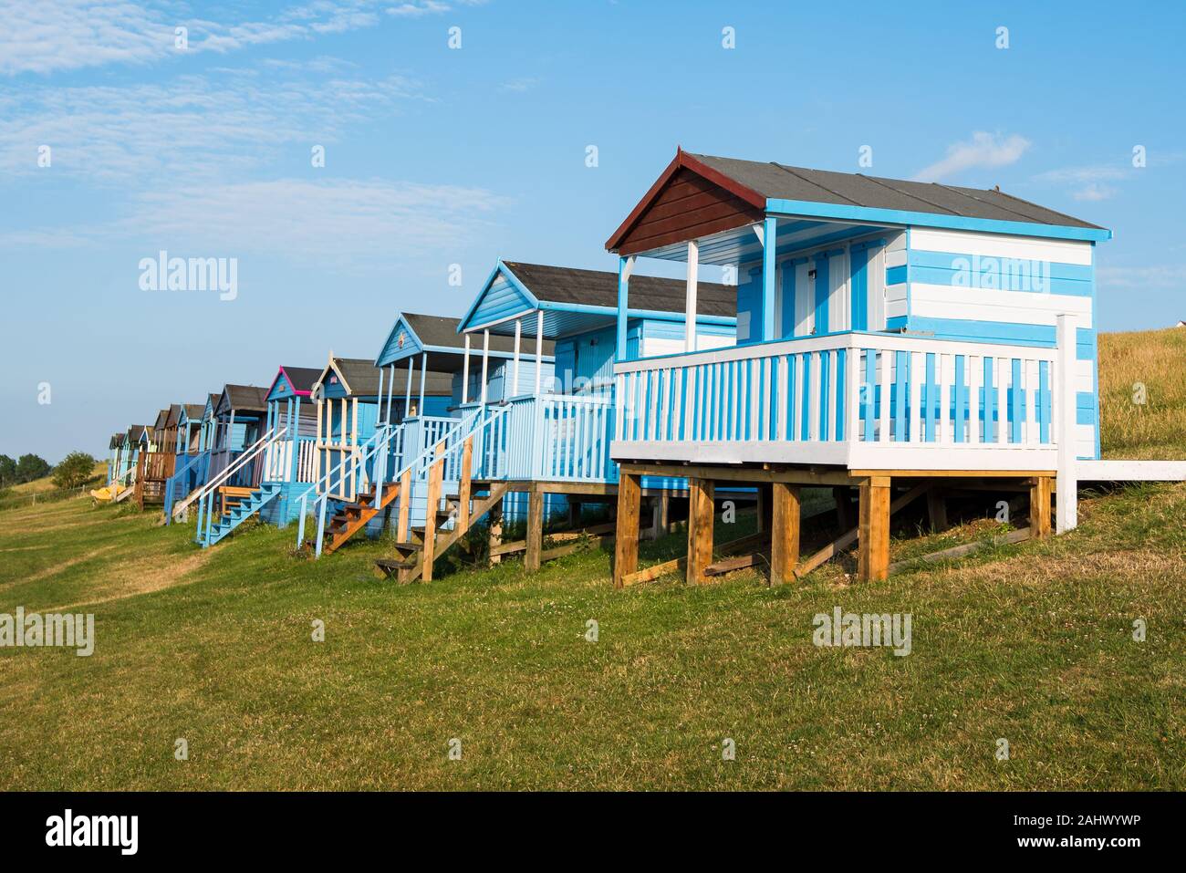 Multicoloured holiday wooden beach huts facing the ocean on the beach