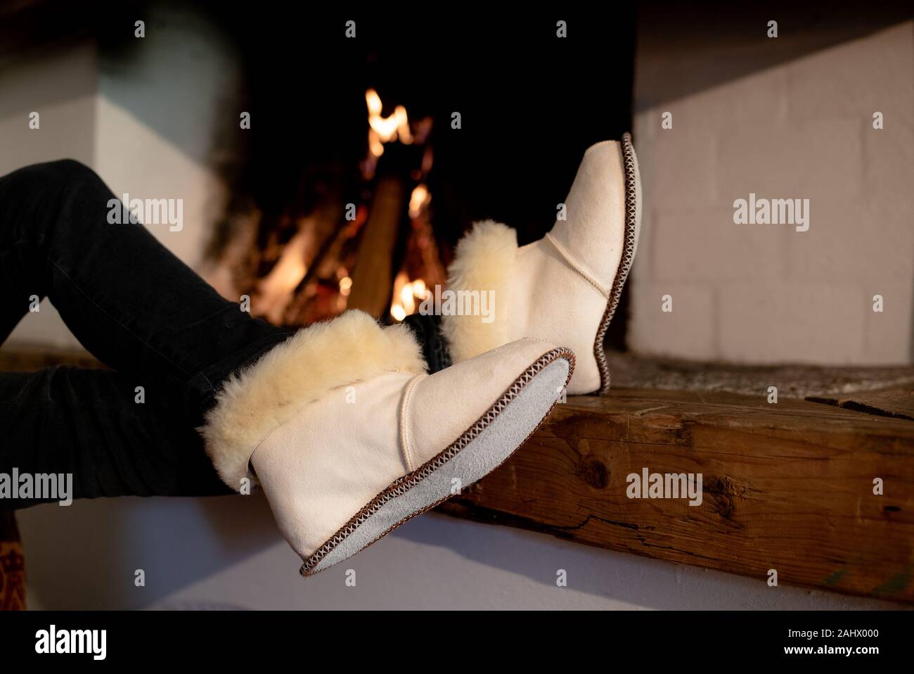 Traditional lamb and sheep wool and fur winter slippers for inside the house. Keep your feet warm and cozy during the freezing cold season Stock Photo