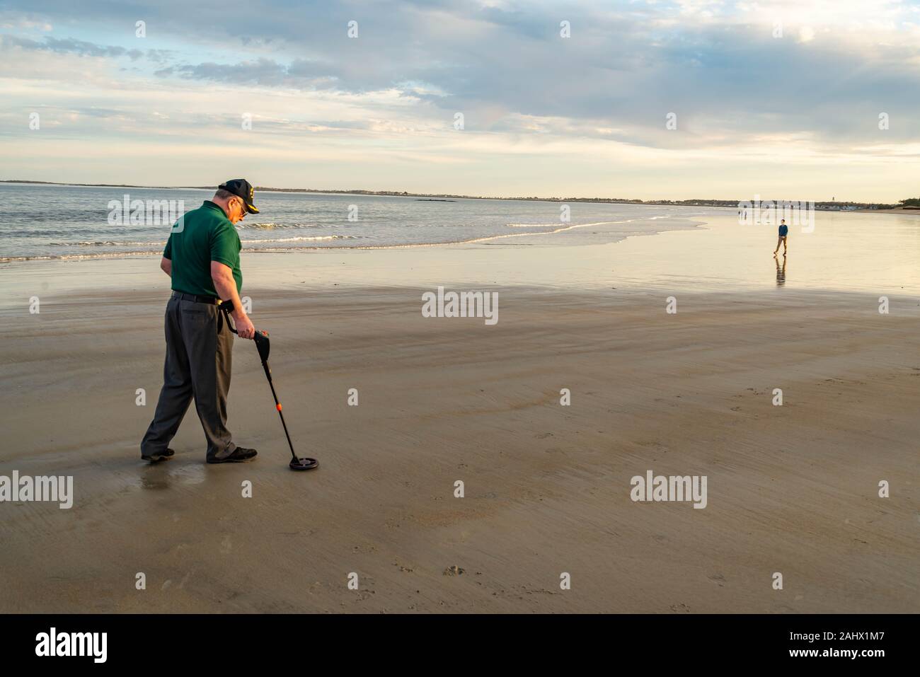 Man using a metal detector to search for lost treasure on a beach Stock ...