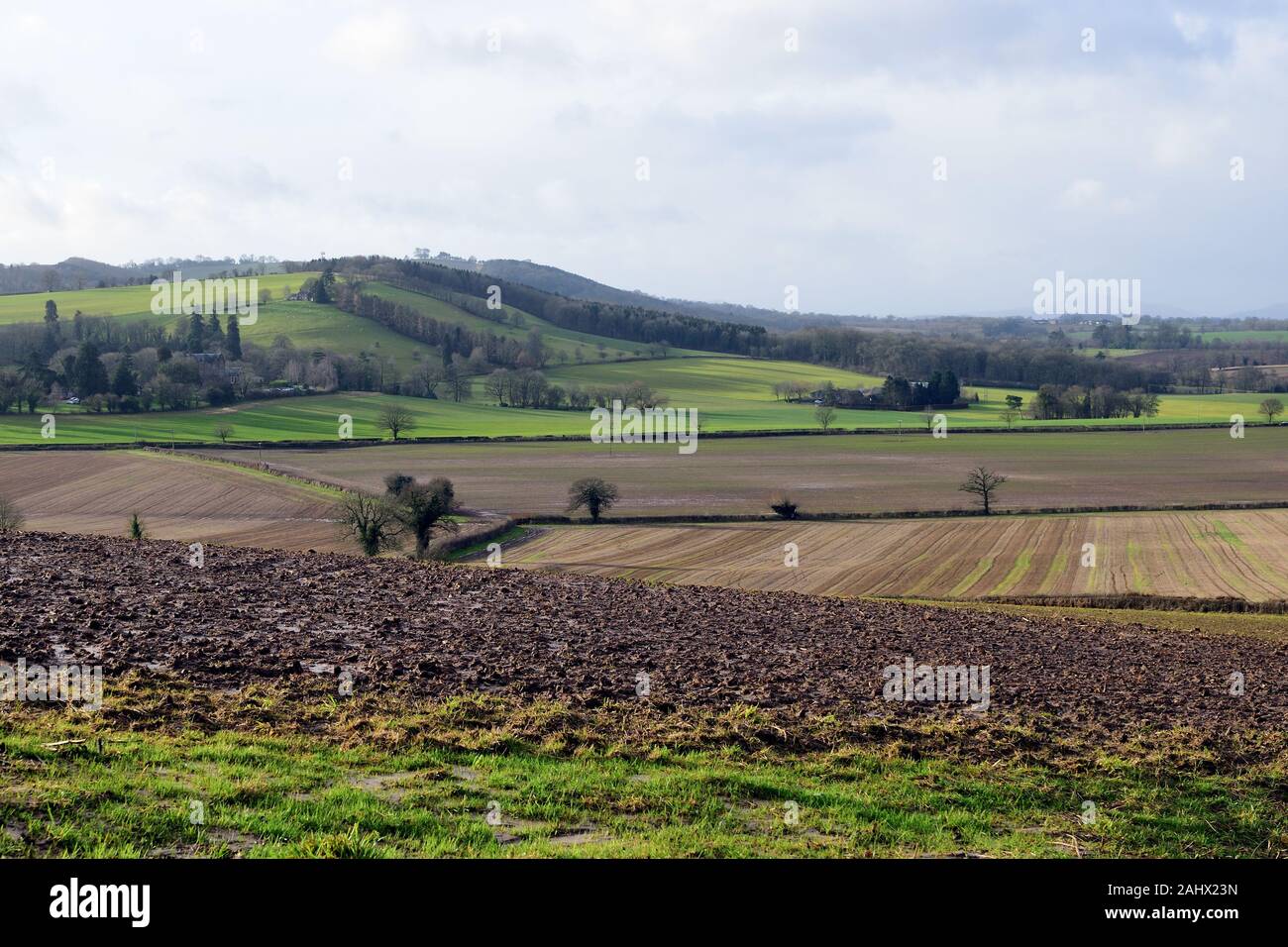 Sun breaking through onto ploughed muddy fields in Herefordshire Stock Photo