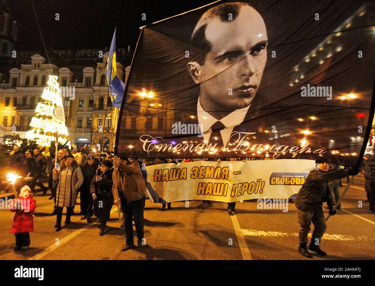 Ukrainian far-right activists carry a Stepan Bandera banner during the ...