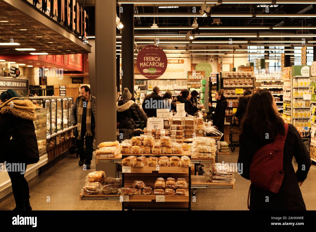 Shoppers perusing the bakery section in the local Whole Foods Market at
