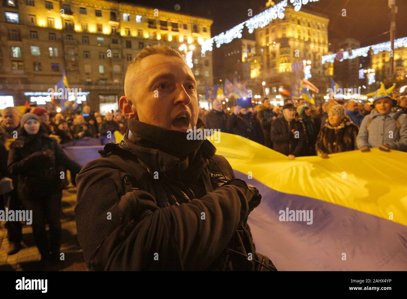 Ukrainian activists sing the Ukrainian anthem during a rally of ...