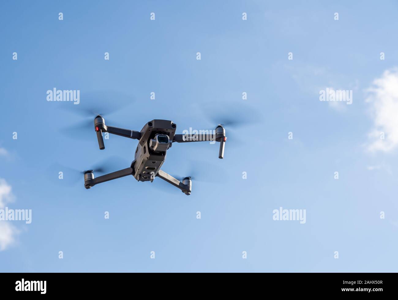 Morgantown, WV - 1 January 2020: DJI Mavic 2 Pro quadcopter or drone hovering in bright blue sky Stock Photo