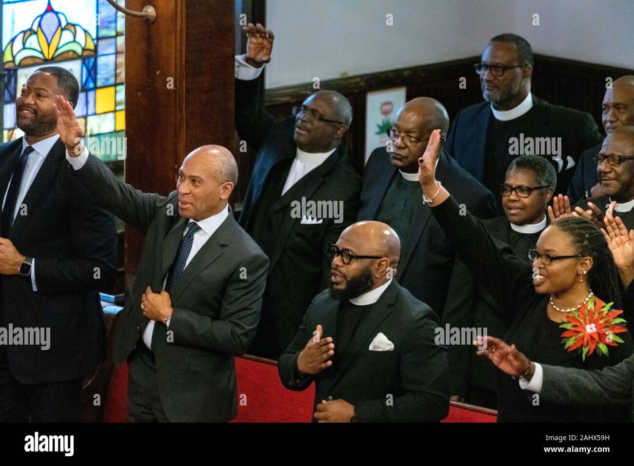 Charleston, United States. 01 January, 2020. Democratic presidential hopeful Gov. Deval Patrick of Massachusetts, left, joins in the worship service at the historic Mother Emanuel AME Church January 1, 2020 in Charleston, South Carolina. The service celebrated Emancipation Day, marking the abolition of slavery in the United States.  Credit: Richard Ellis/Alamy Live News Stock Photo