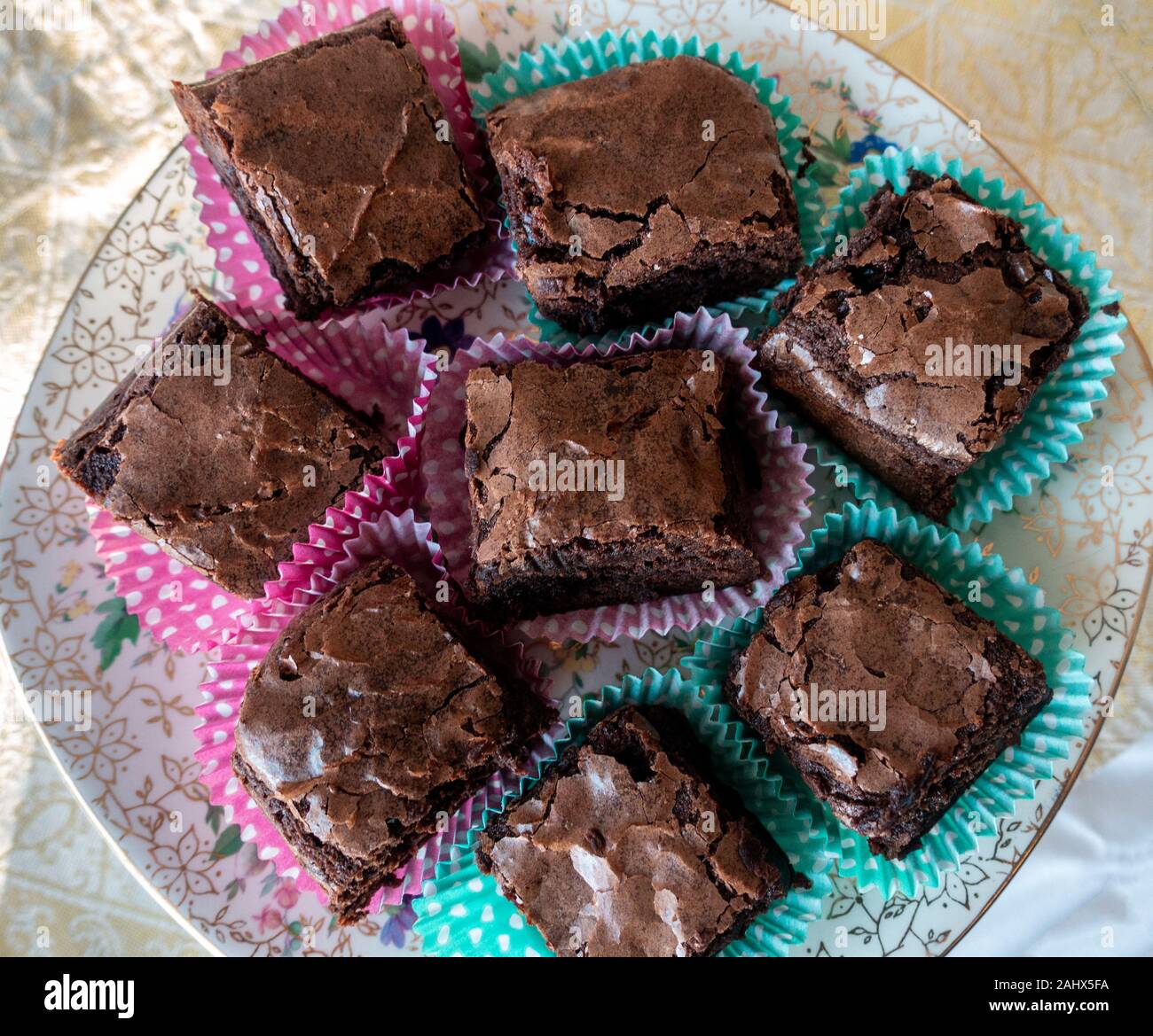 A plate of homemade chocolate brownies in paper cases seen from above Stock Photo