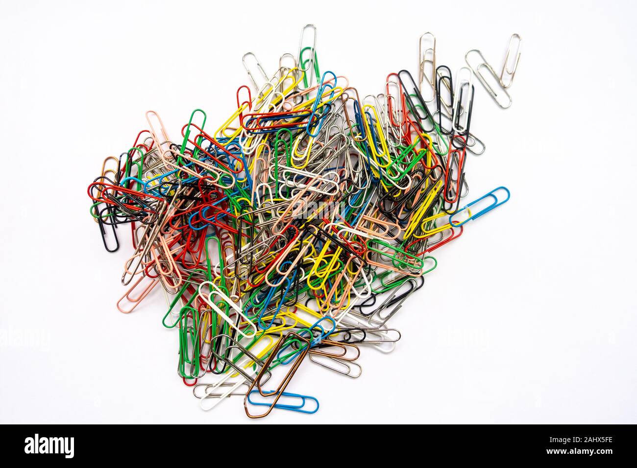 A pile of paper clips against a white background. Stock Photo