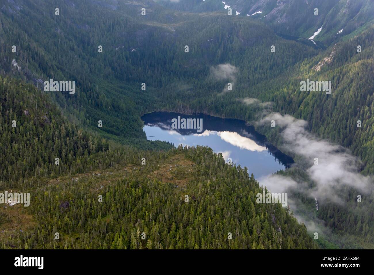 Mountain lake with reflections and morning mists, Great Bear Rainforest, coastal British Columbia Stock Photo