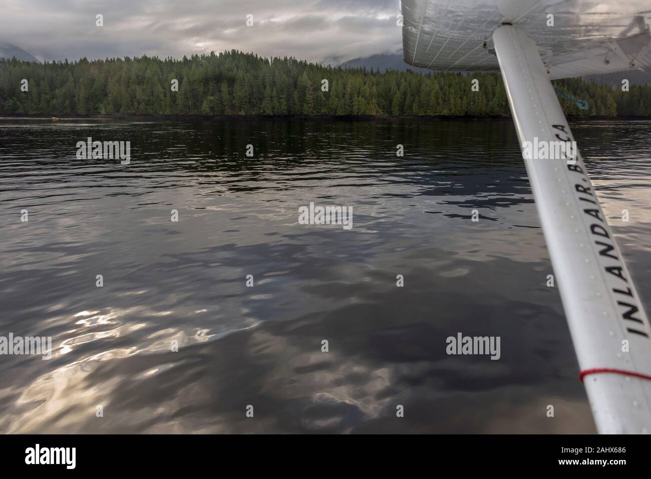 Inlandair seaplane taking off from Seal Cove with sky reflections, Prince Rupert, British Columbia Stock Photo