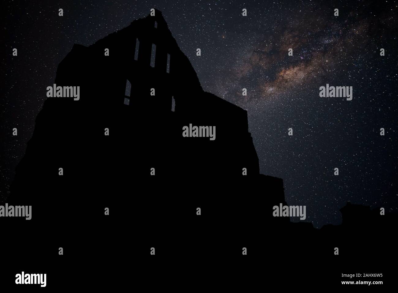 Ancient stone ruins at night time with stars in the sky Stock Photo