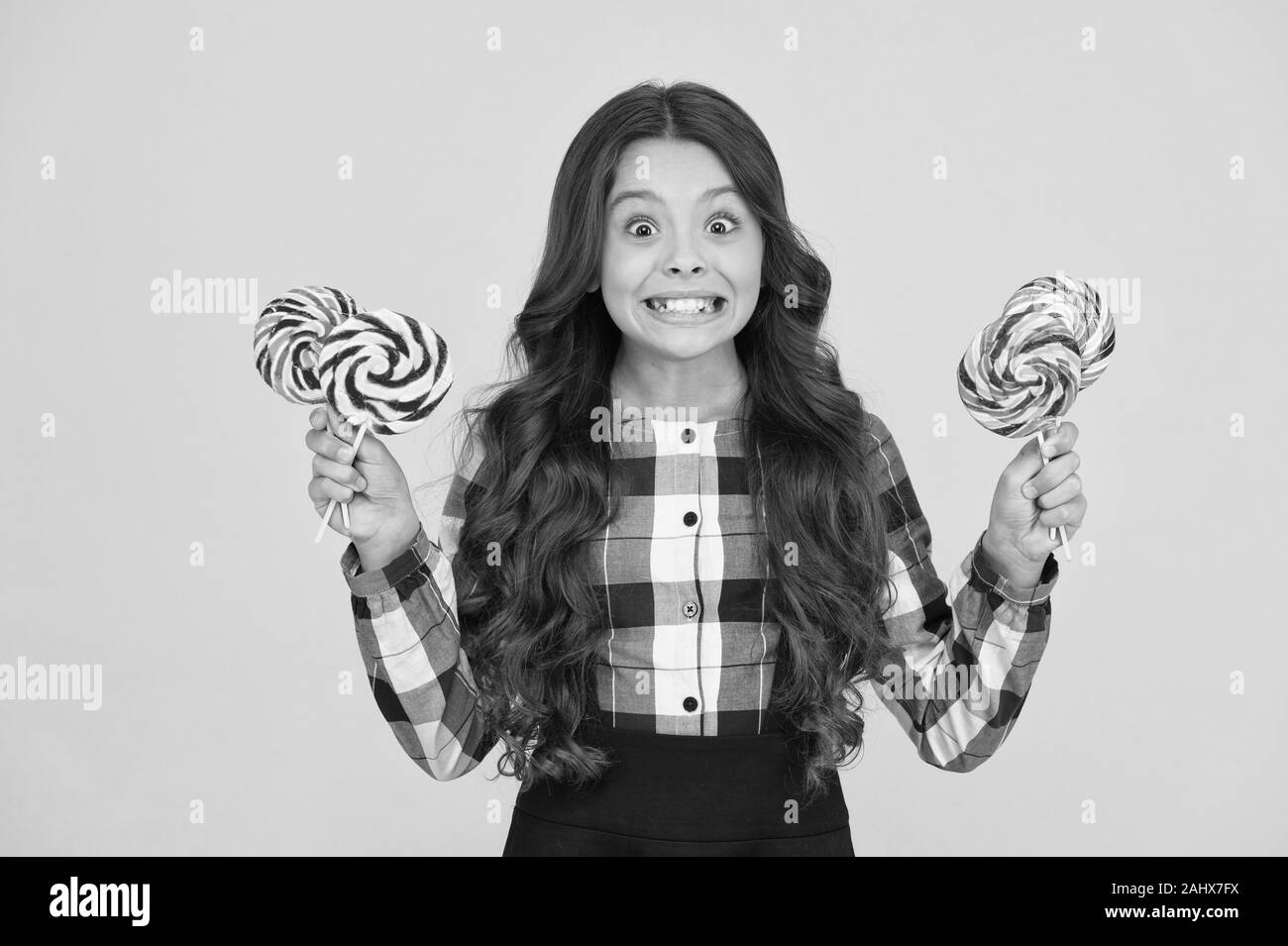 Always eat dessert first. Happy small schoolchild hold candy dessert on