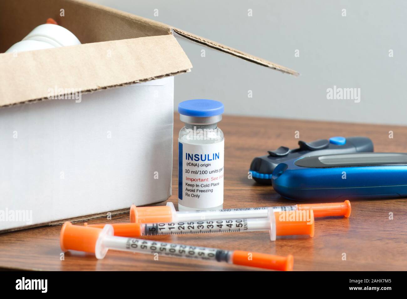 Insulin vial with syringes, test strips and other diabetic medical supplies and mailing postal box. Stock Photo
