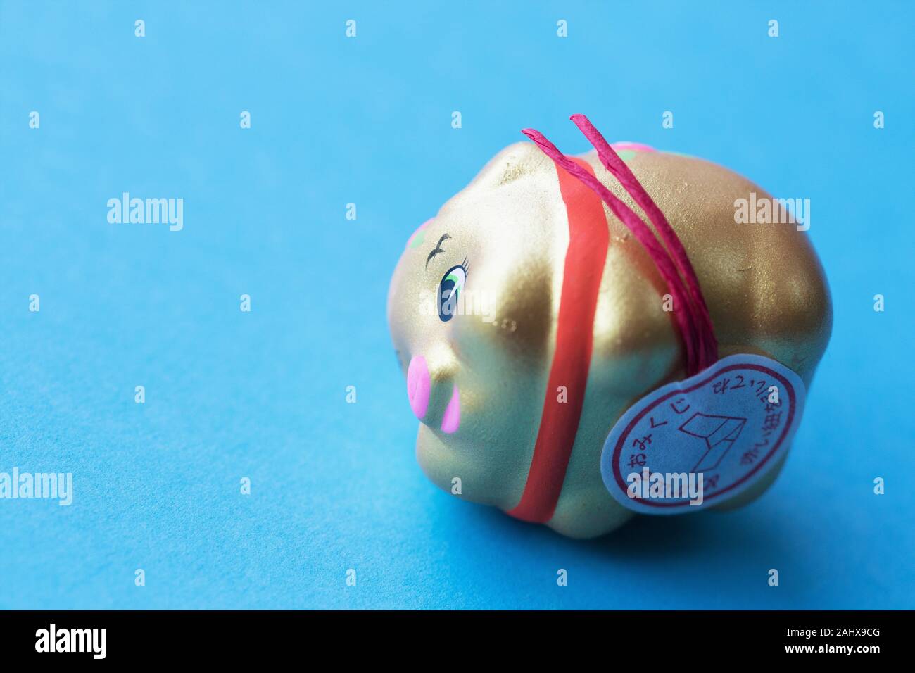 A Japanese pig figurine filled with a fortune and seeds to plant for good luck Stock Photo Alamy
