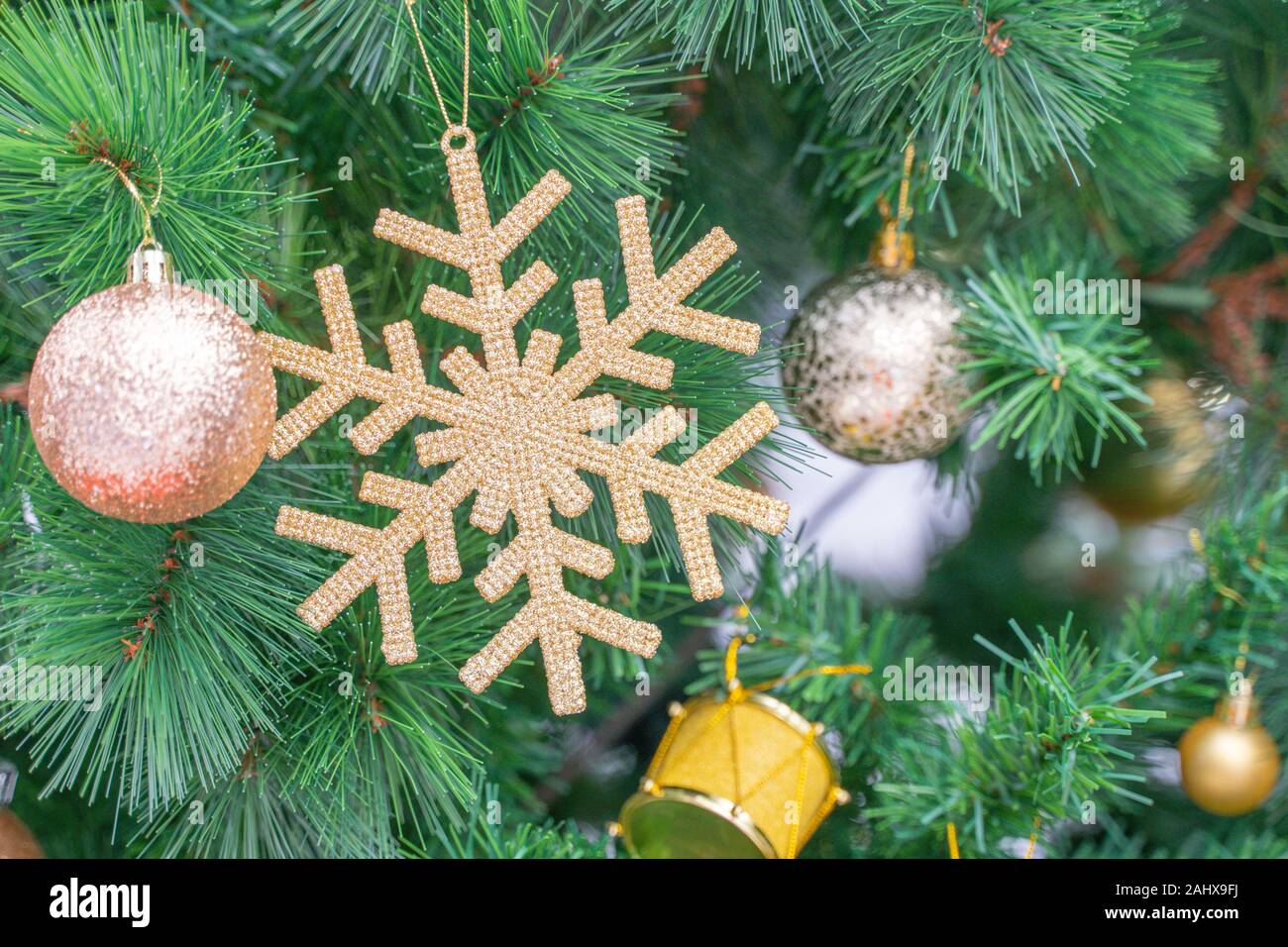 Beautiful Christmas star hanging from a decorated Christmas tree Stock Photo
