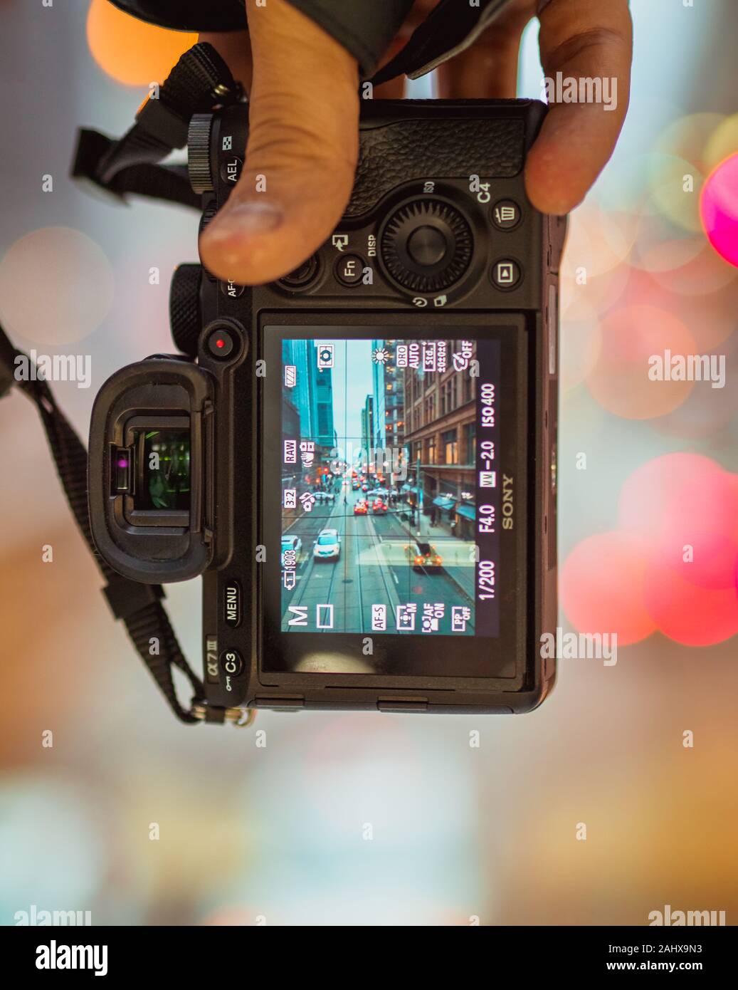Holding Sony Alpha 7 III showing streets of Toronto, Ontario, Canada with traffic flowing in both directions Stock Photo