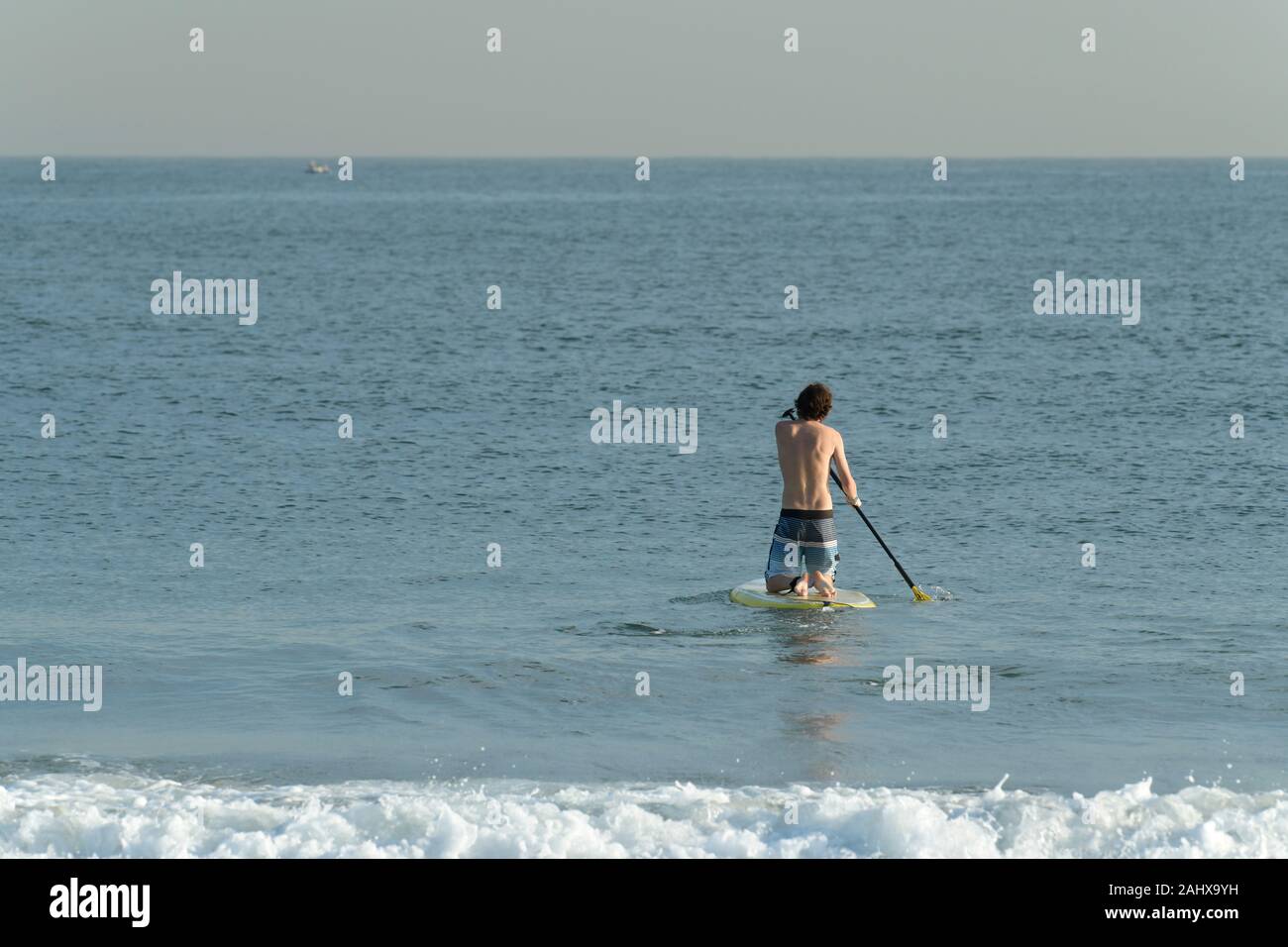 Rear view man body board hires stock photography and images Alamy