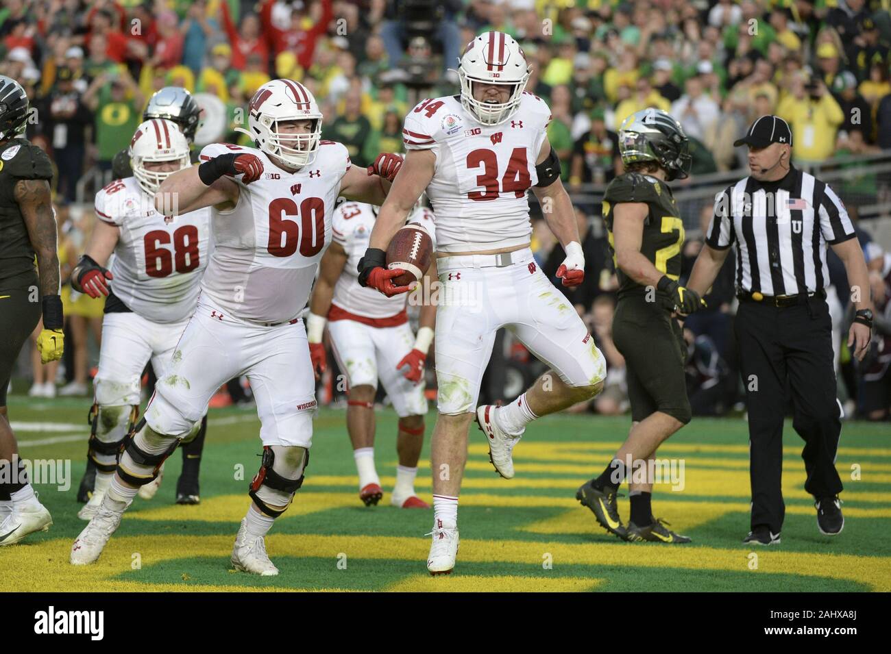 Anaheim, CA, USA. 1st Jan, 2020. Rose Bowl 2020: Wisconsin Badgers fullback Mason Stokke (34) celebrates his rushing touchdown with Badgers offensive lineman Logan Bruss (60) during the 2020 Rose Bowl game as the Oregon Ducks play the Wisconsin Badgers at the Rose Bowl in Pasadena, CA. Credit: Jeff Halstead/ZUMA Wire/Alamy Live News Stock Photo