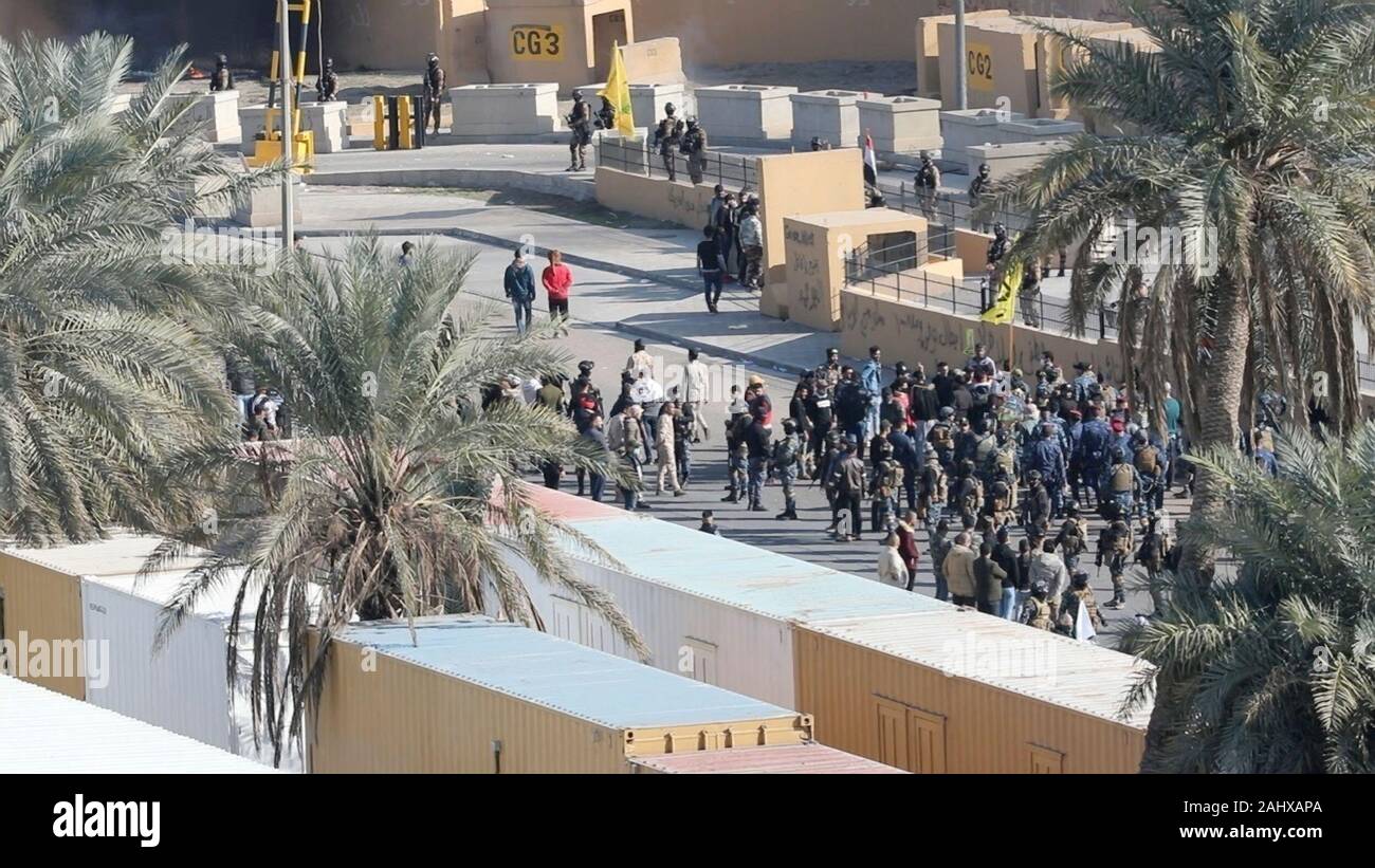 Baghdad, Iraq. 01 January, 2020. Groups of violent protesters from the Iran-backed Kataib Hezbollah militia confront Iraqi security forces outside the U.S. Embassy Compound January 1, 2020 in Baghdad, Iraq. Credit: Maj. Charlie Dietz/Planetpix/Alamy Live News Stock Photo