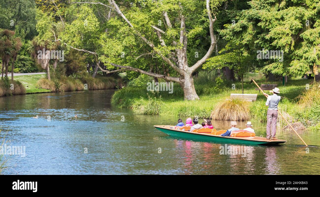 Christchurch, New Zealand - December 1st, 2018: Sightseers enjoy being punted down the Avon river in a small, flat-bottomed boat poled by a guide dres Stock Photo