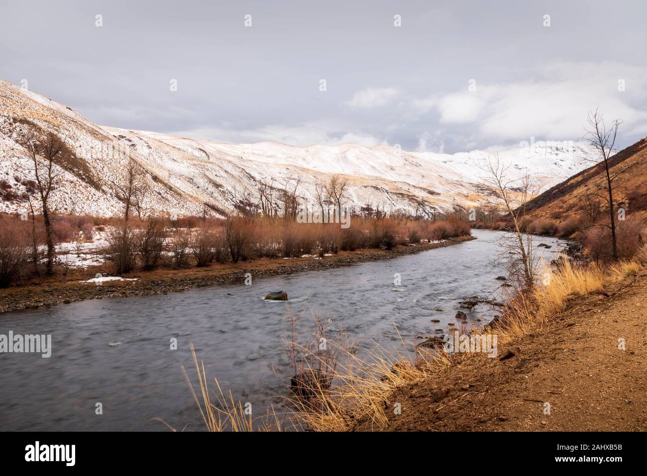 Beautiful view of the South Fork of the Boise RIver in the winter with snow on the hills. Stock Photo