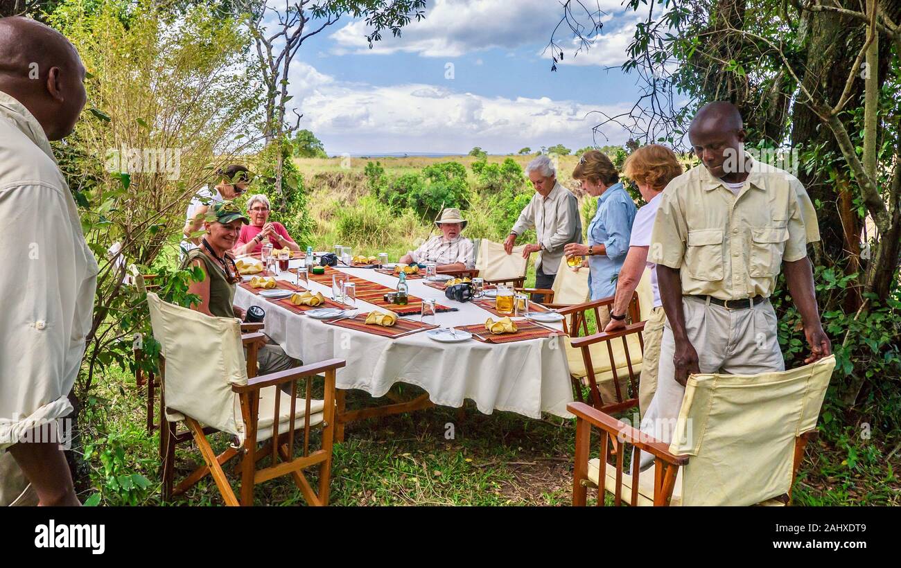 Masai Mara, Kenya - September 29, 2013. Pensioners enjoying retirement, as they eat an al fresco lunch while on a deluxe safari. Stock Photo
