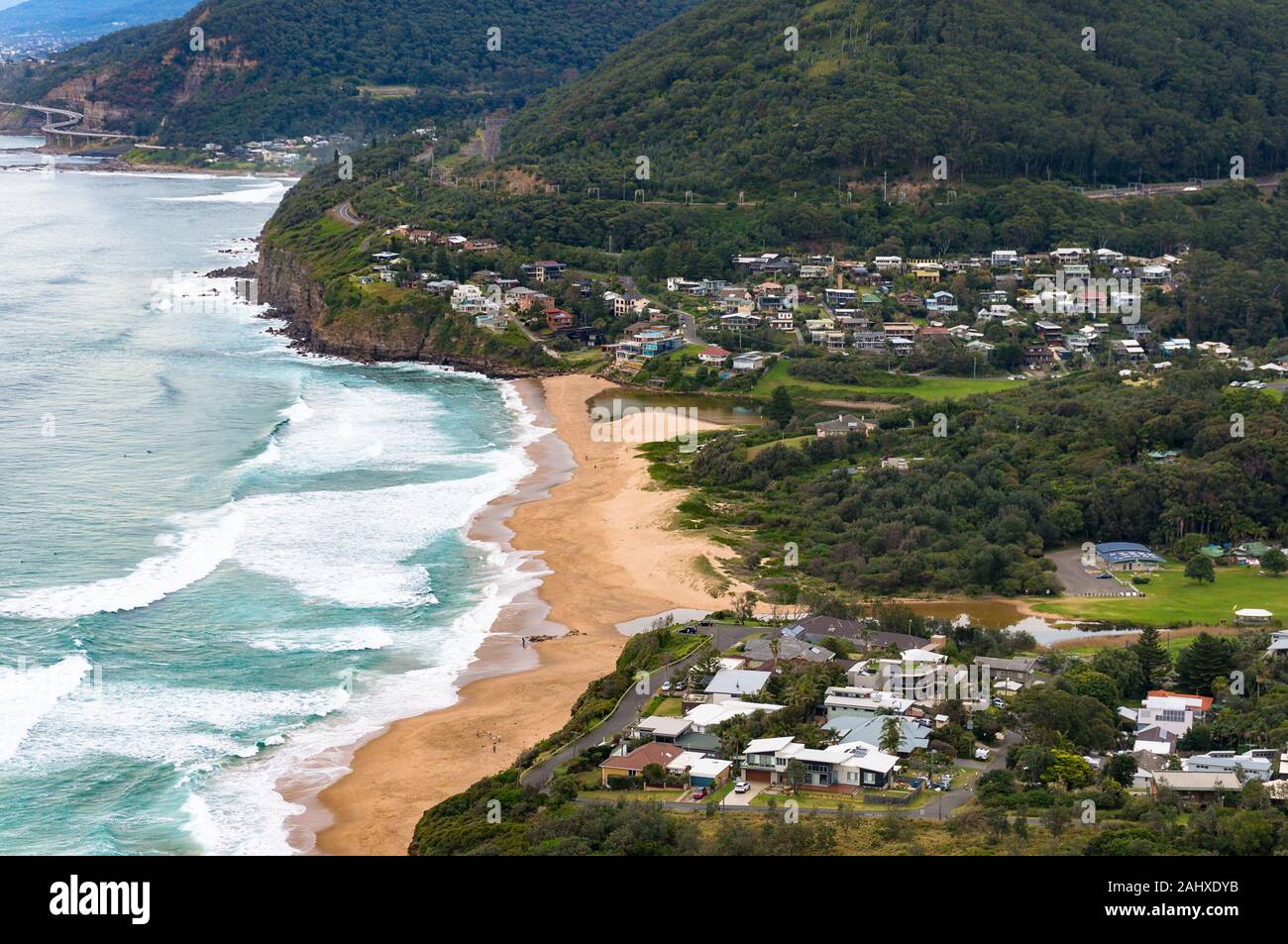 Aerial view on picturesque landscape of ocean beach and town among mountains. Stanwell beach, Australia Stock Photo