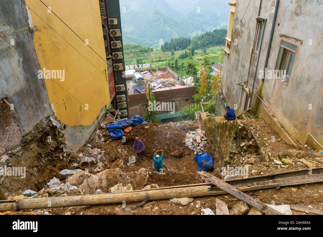 Sapa, Vietnam - August 19, 2017: Workers, builders at construction site in Sapa. Sapa is rapidly developing tourist attraction and popular travel dest Stock Photo
