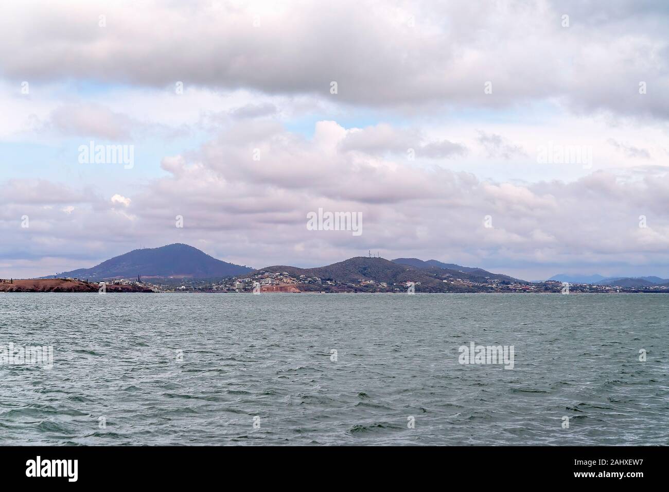 The small coastal town of Yeppoon on the Capricon Coast of Australia as seen from the ocean on a cloudy and windy day Stock Photo