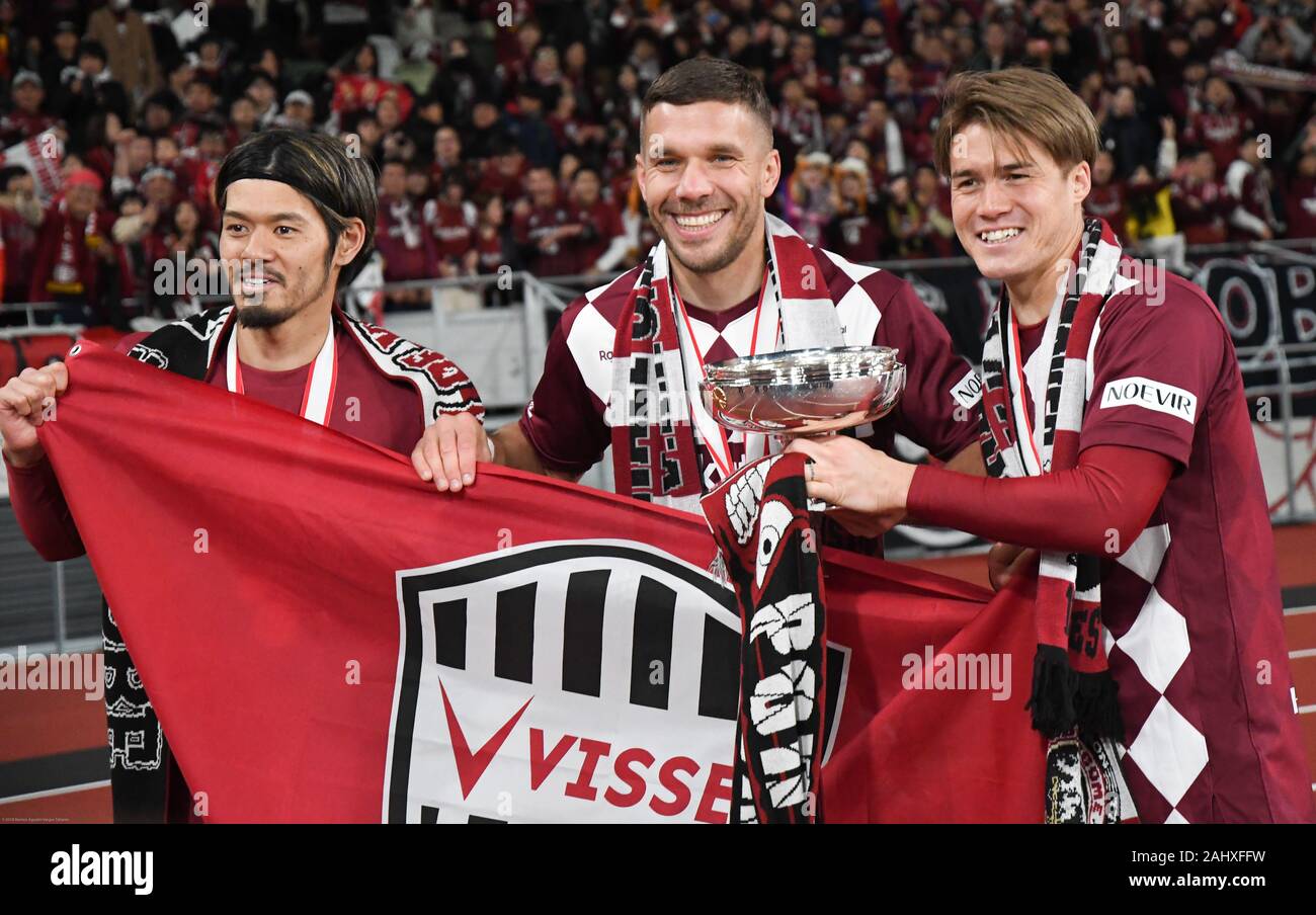 Tokyo, Japan. 1st Jan, 2020. (from left) Yamaguchi Hotaru, Lukas Podolski, and Gotoku Sakai of Vissel team pose for a photo during a moment of celebration. Vissel Kobe football team premieres at Tokyo National Stadium in Japan, becoming the first ever Vissel Kobe team to win an Emperor's Cup JFA championship. The game was held at the stadium that will serve as the main venue of the Tokyo 2020 Olympic Games. Photo taken onã€€Wednesday January 1, 2020. Photo by: Ramiro Agustin Vargas Tabares Credit: Ramiro Agustin Vargas Tabares/ZUMA Wire/Alamy Live News Stock Photo