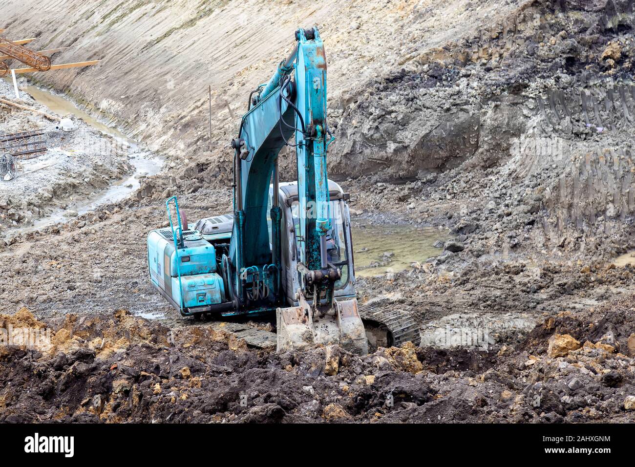 Excavator digging foundation at construction site. Excavator working