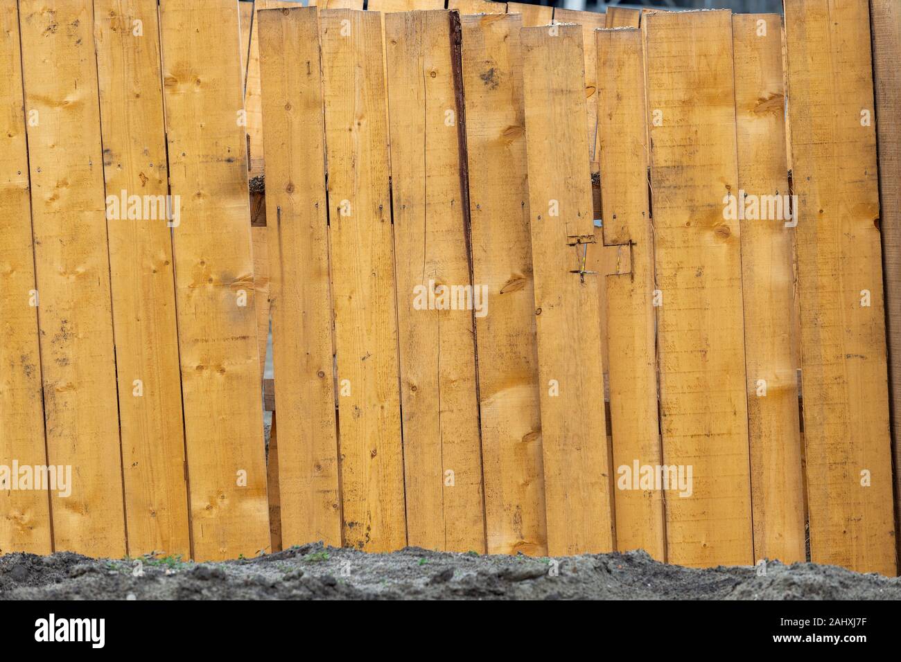 Wooden boards supports to protect the walls of the trench from collapsing. Trench walls are