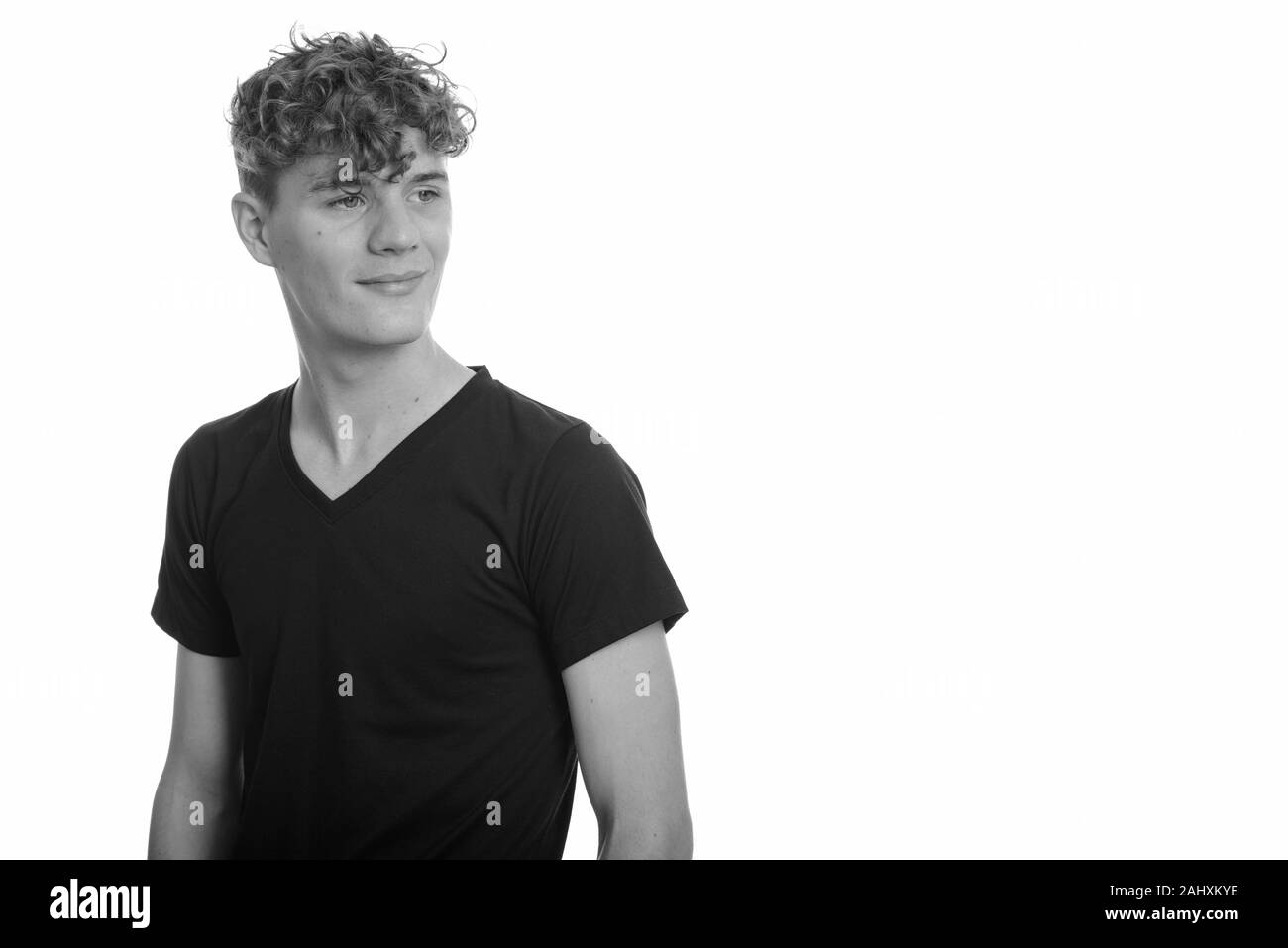 Portrait of young handsome man with curly hair Stock Photo - Alamy