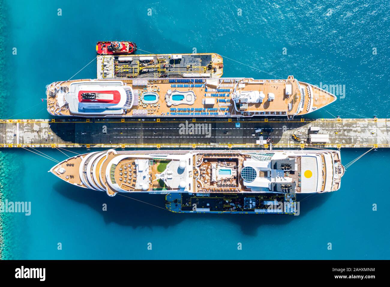 Aerial view of two giant cruise ships moored in the port of Philipsburg along with three barges, island of Sint Maarten, Dutch Antilles, West Indies, Stock Photo