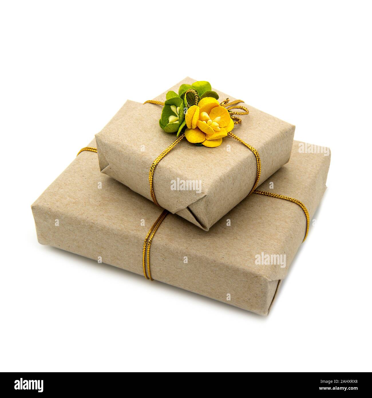 Two boxes packed in brown paper with yellow and green paper flowers Stock Photo Alamy
