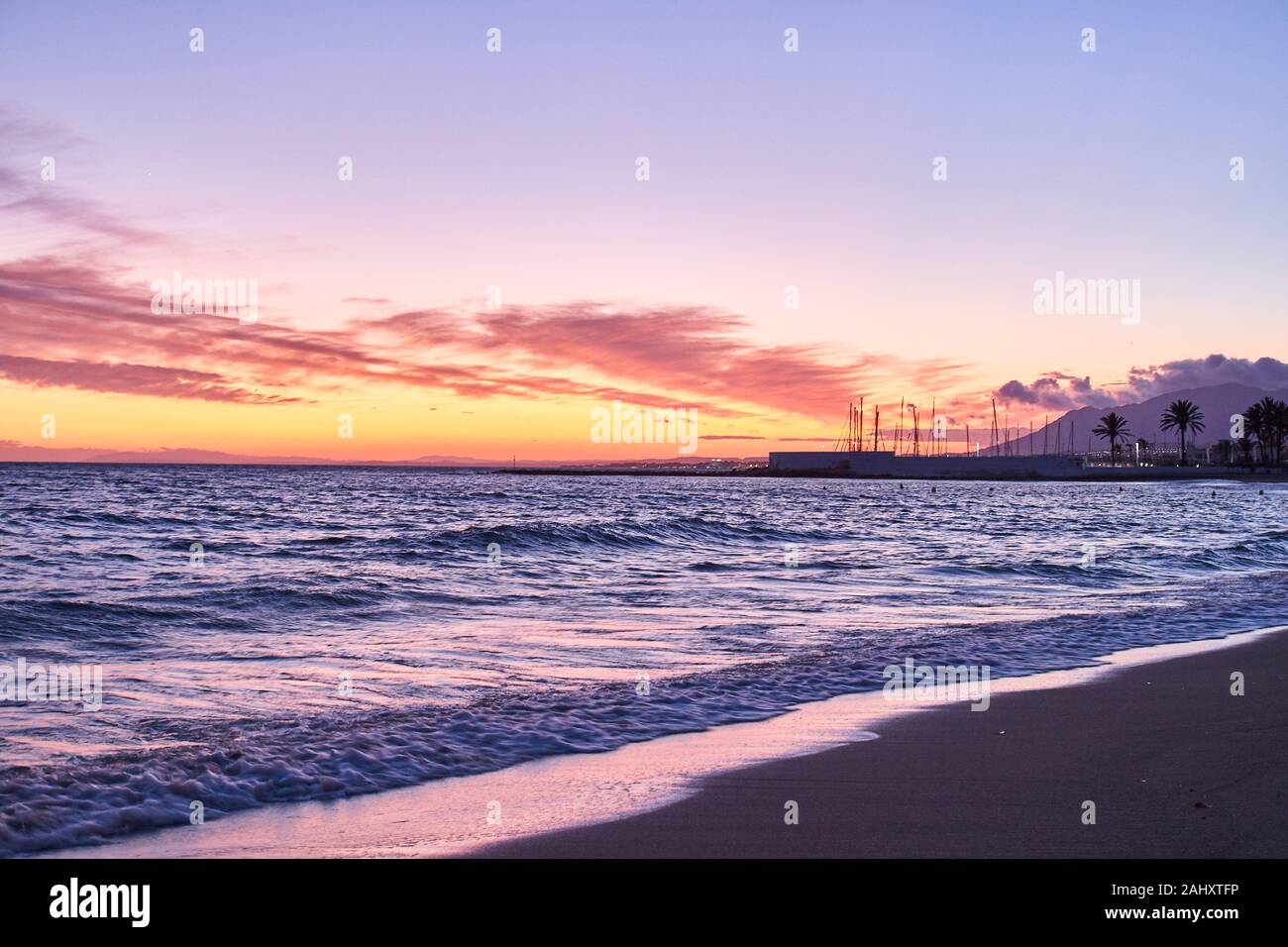 Sunset in Marbella beach with nice reflectiion and colors. Stock Photo