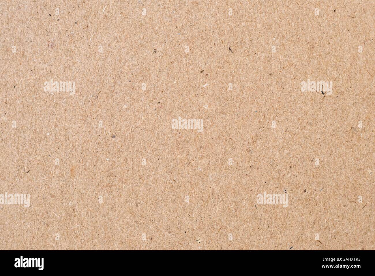 Light brown wrapping paper. Natural sheet surface, packaging background. Texture of cardboard, pasteboard, stiff paper Stock Photo