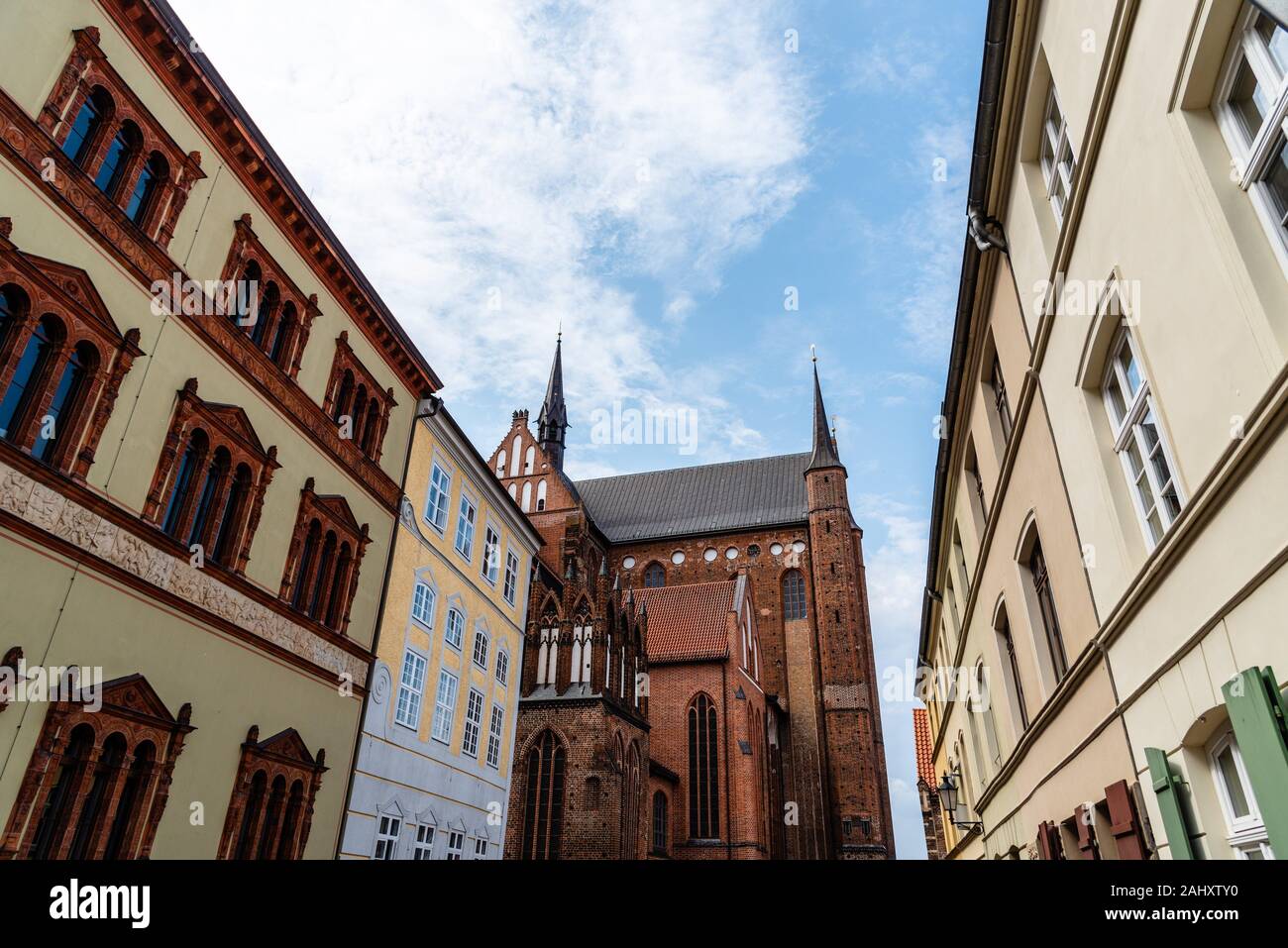 Old houses and St. George church in historic centre of Wismar, Germany. Stock Photo