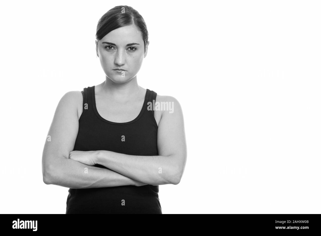 Studio shot of beautiful woman looking angry with arms crossed Stock Photo