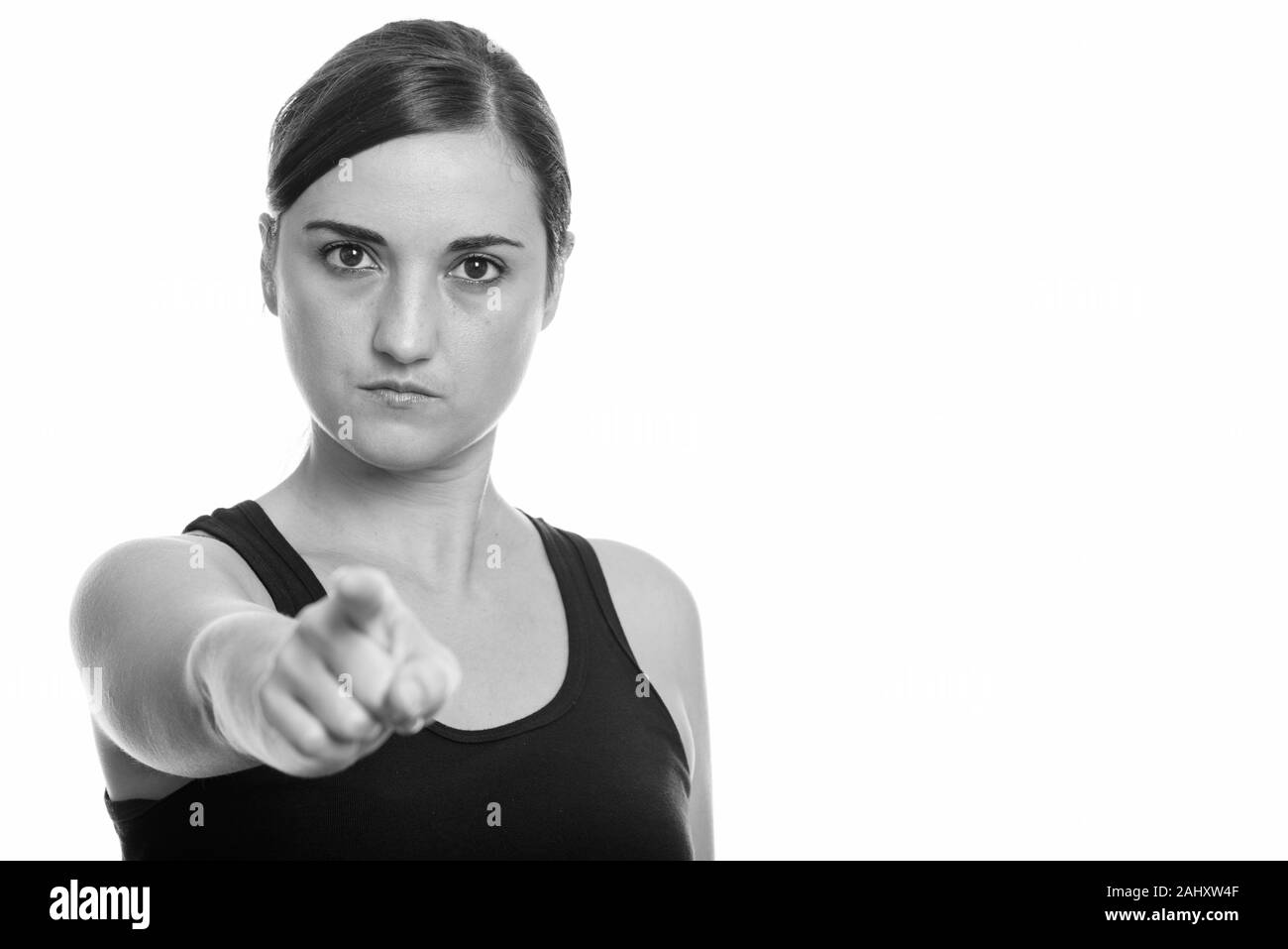 Studio shot of beautiful woman looking angry while pointing finger at camera Stock Photo