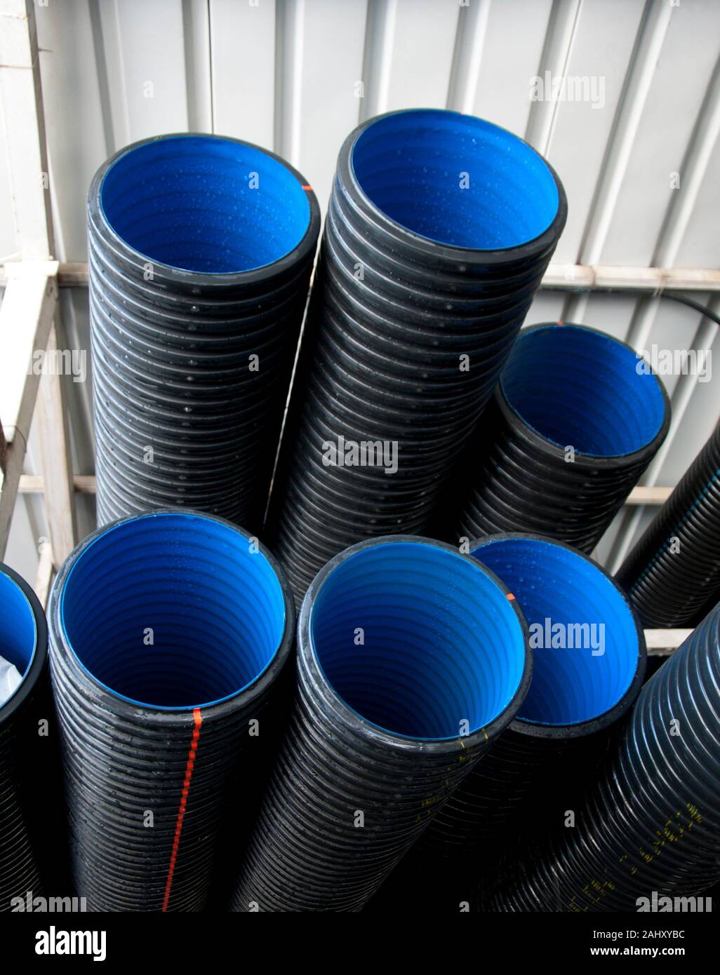 Black PVC pipes arranged on shelves Stock Photo Alamy