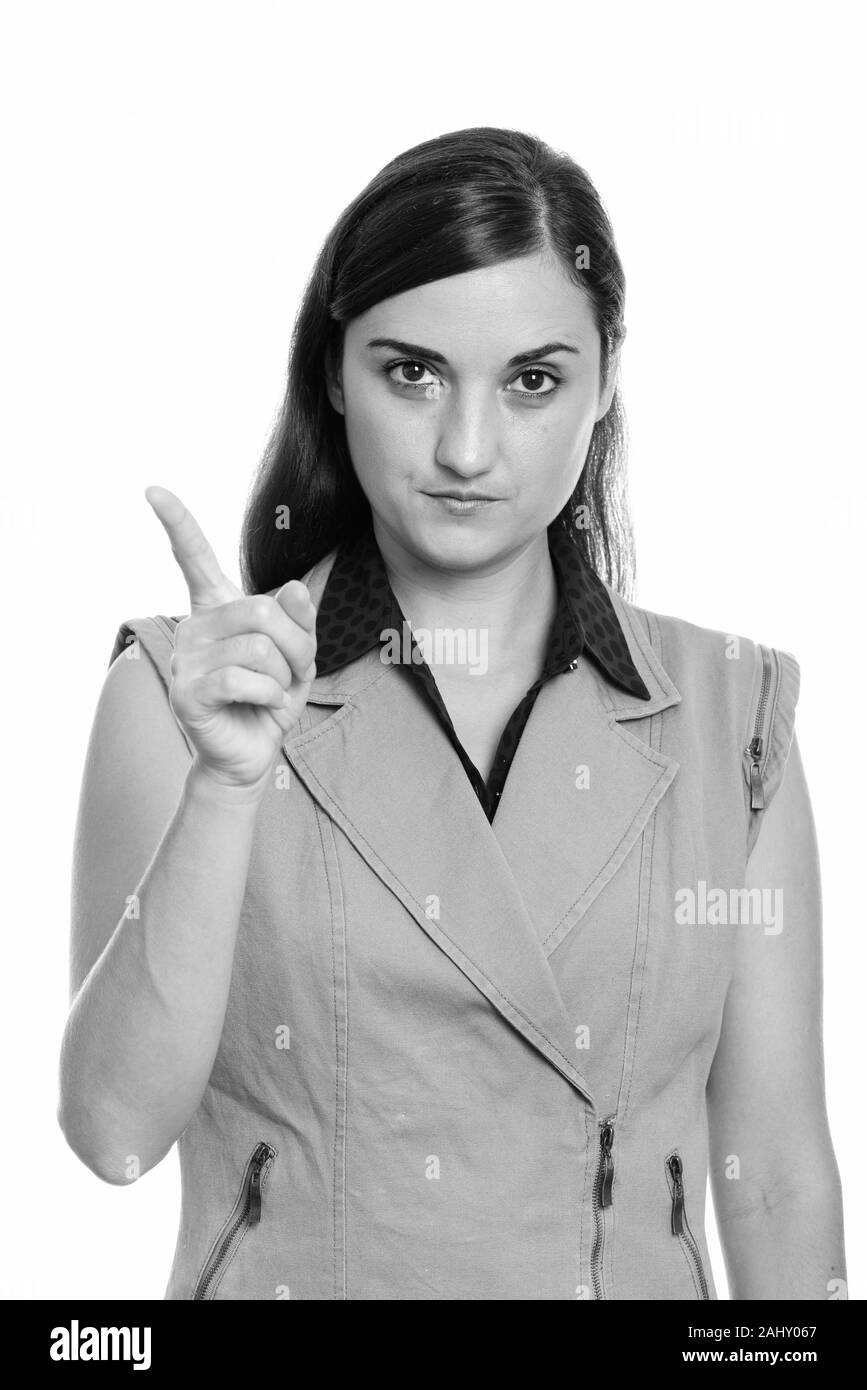 Studio shot of angry businesswoman pointing finger Stock Photo