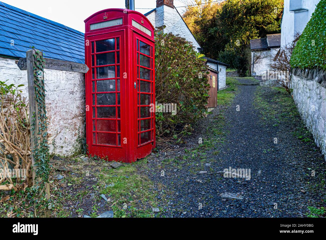 Bucks Mills, Phone Box and South West Coast Path Out of the Village With Signpost to Peppercombe 2 1/2 miles, Bucks Mills, Devon, Great Britain. Stock Photo