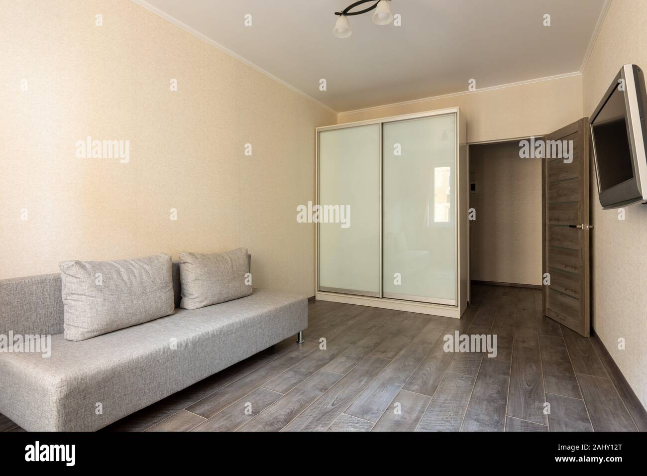 Interior of a small hotel room, TV, wardrobe and sofa Stock Photo Alamy